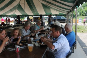 The Pala and Konecny families enjoy chicken dinner at the parish festival.