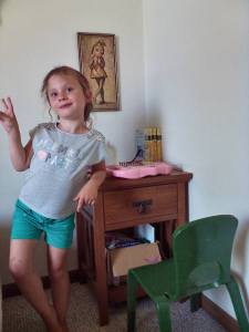 Ella by her computer station in her girl's room.